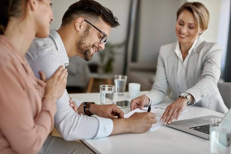 happy-man-his-wife-having-meeting-with-financial-advisor-signing-agreement-office_637285-6121