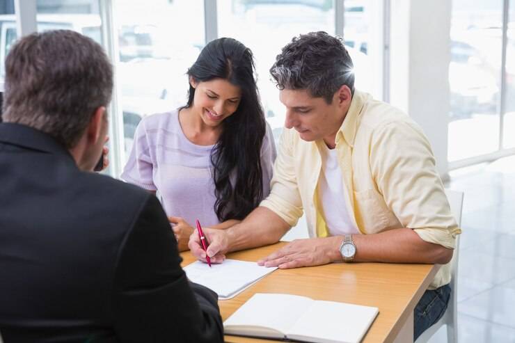 smiling-couple-signing-contract_13339-289715